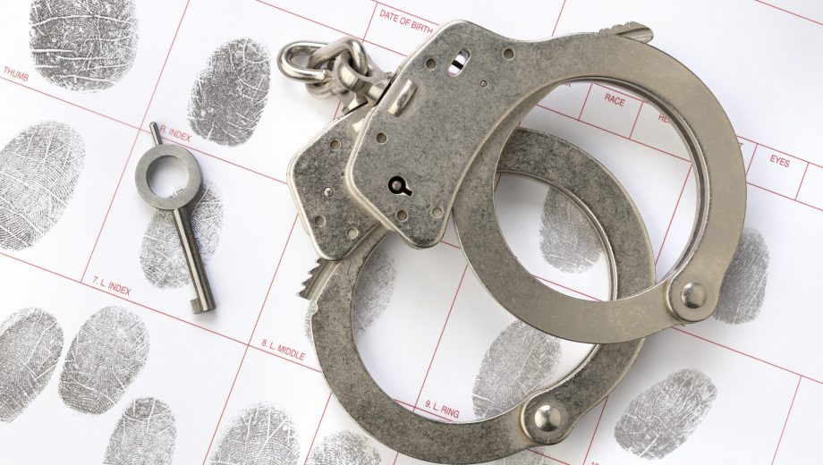 Handcuffs on fingerprint card